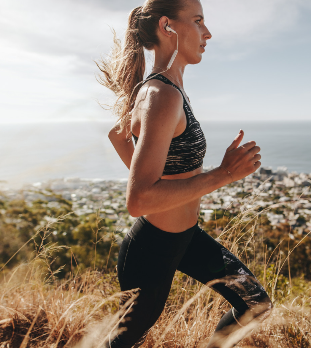 Woman running outdoors with a scenic background