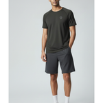 Man wearing a black underscored plastic-free t-shirt and grey shorts on a light gray background