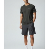 Man wearing a black underscored plastic-free t-shirt and grey shorts on a light gray background