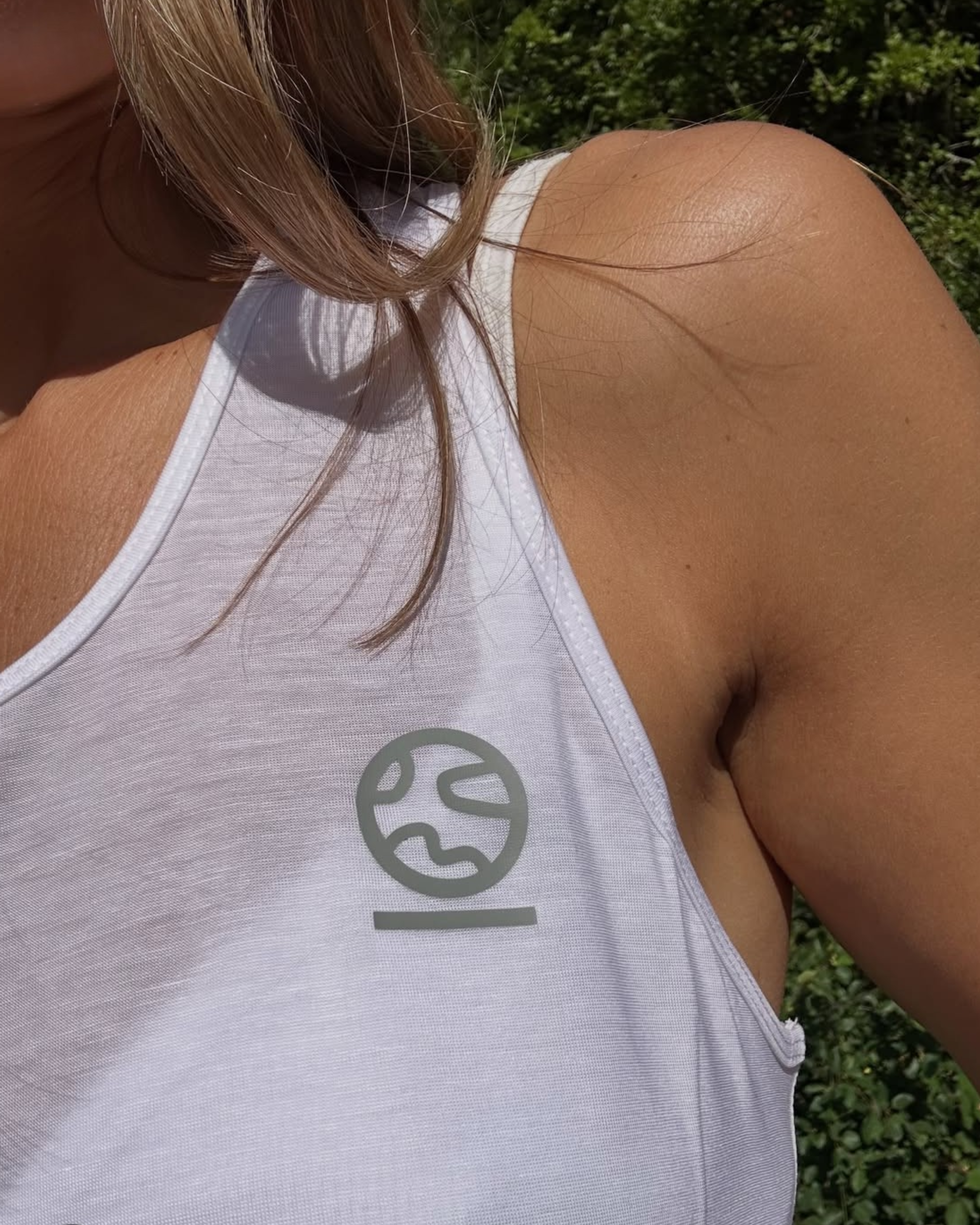 Close-up of the Underscored Women's Ashdown Tank in White showing the TENCEL Lyocell fabric texture and tonal Underscored logo, made without plastic fibres