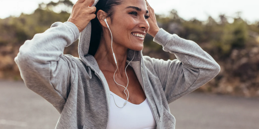 Woman in athletic wear with earphones outdoors