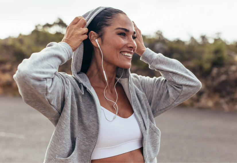 Woman in athletic wear with earphones outdoors